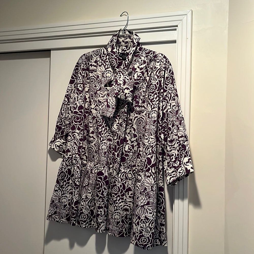 The Oula Co tunic swing blouse with tie neck.  Dark grape and cream pattern.